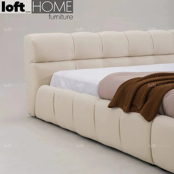 Contemporary suede fabric bed tufty in still life.