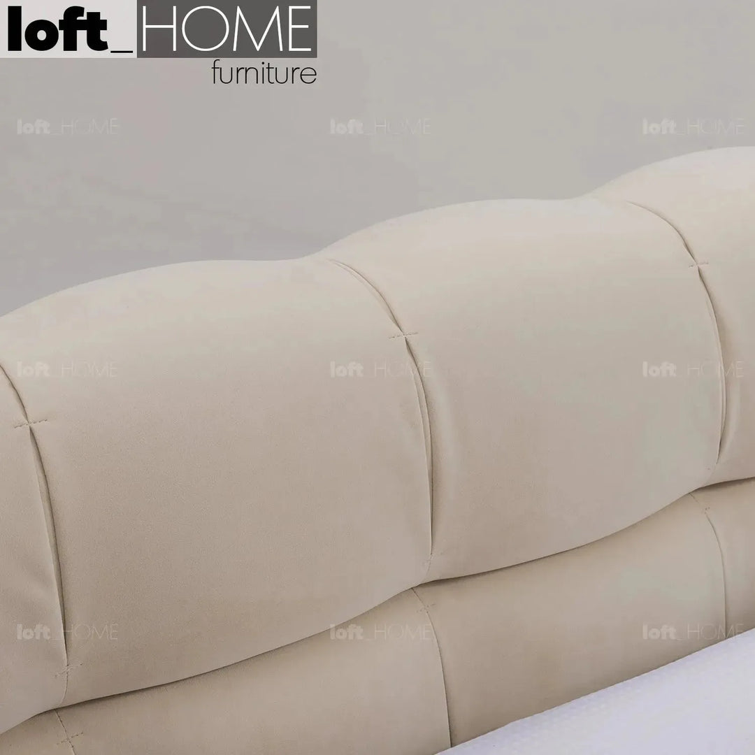 Contemporary suede fabric bed tufty in panoramic view.