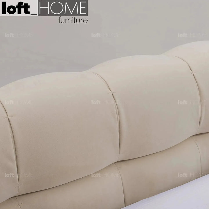 Contemporary suede fabric bed tufty in panoramic view.