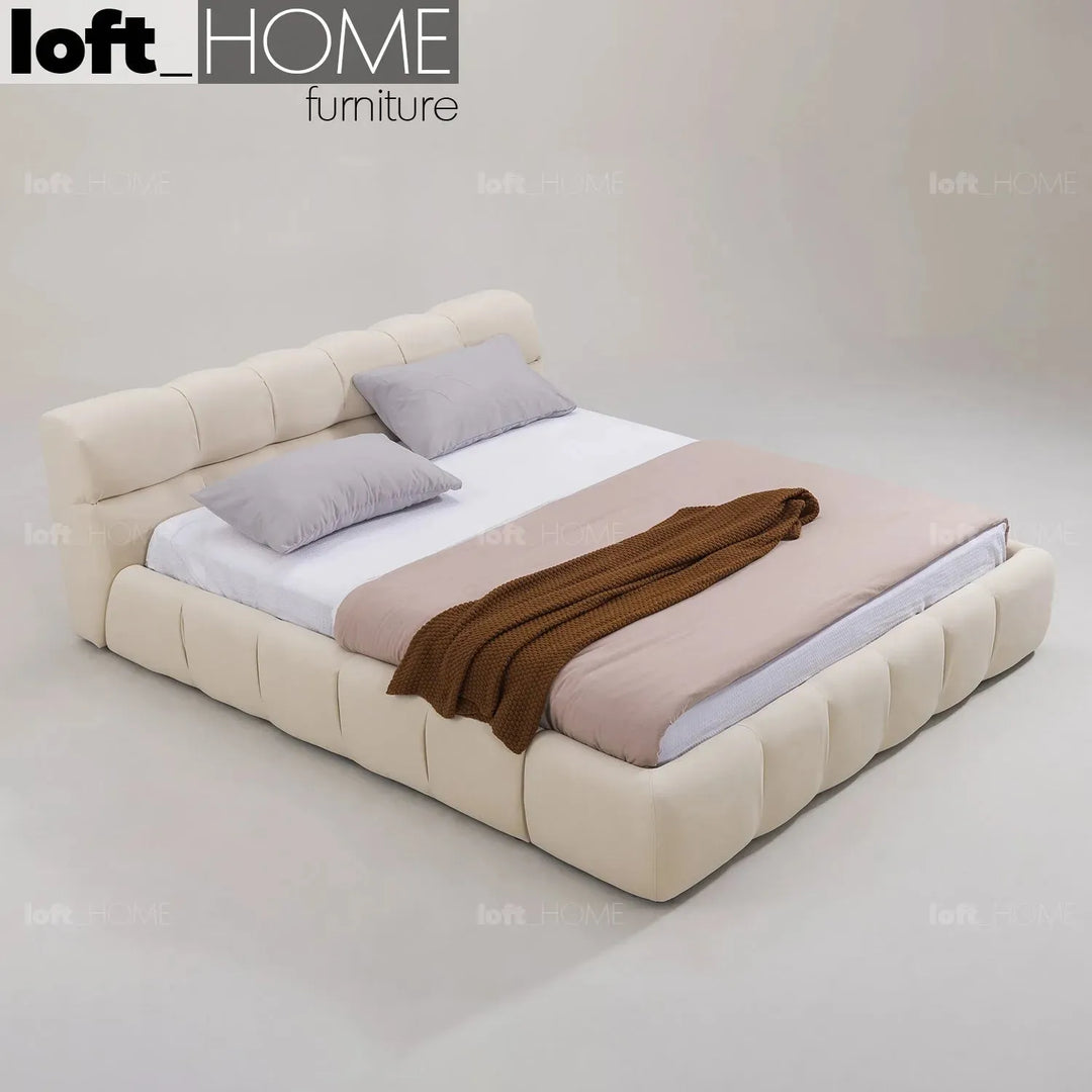 Contemporary suede fabric bed tufty with context.