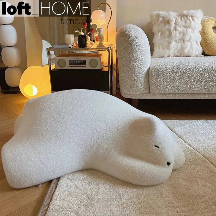 Contemporary velvet ottoman resting bear white primary product view.