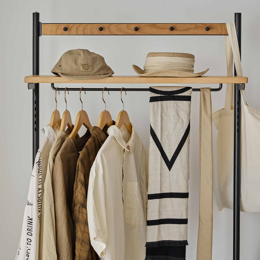Scandinavian cherry wood clothes hanger cove in still life.