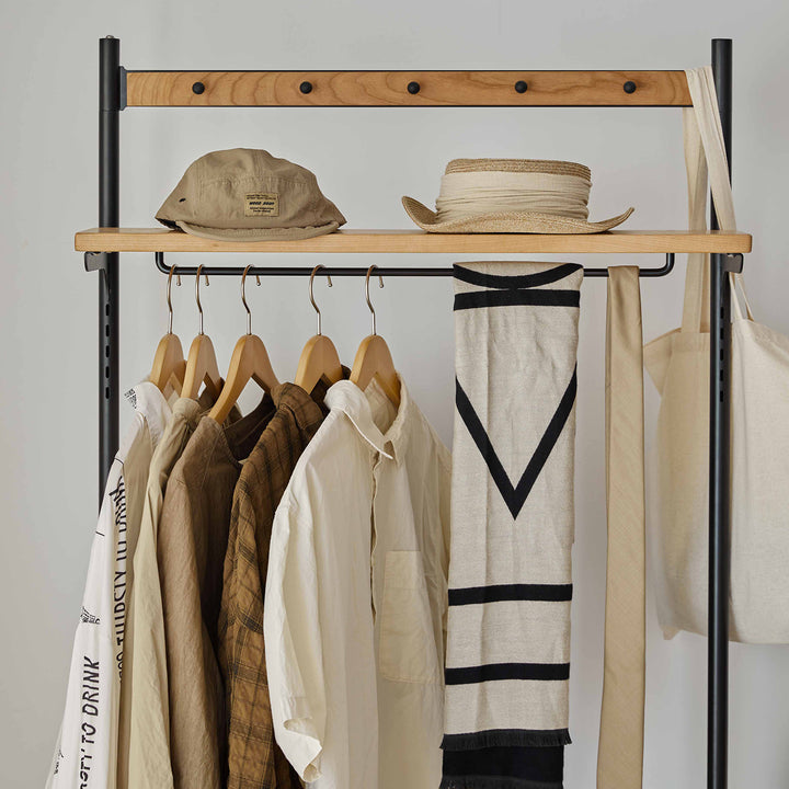 Scandinavian cherry wood clothes hanger cove in still life.