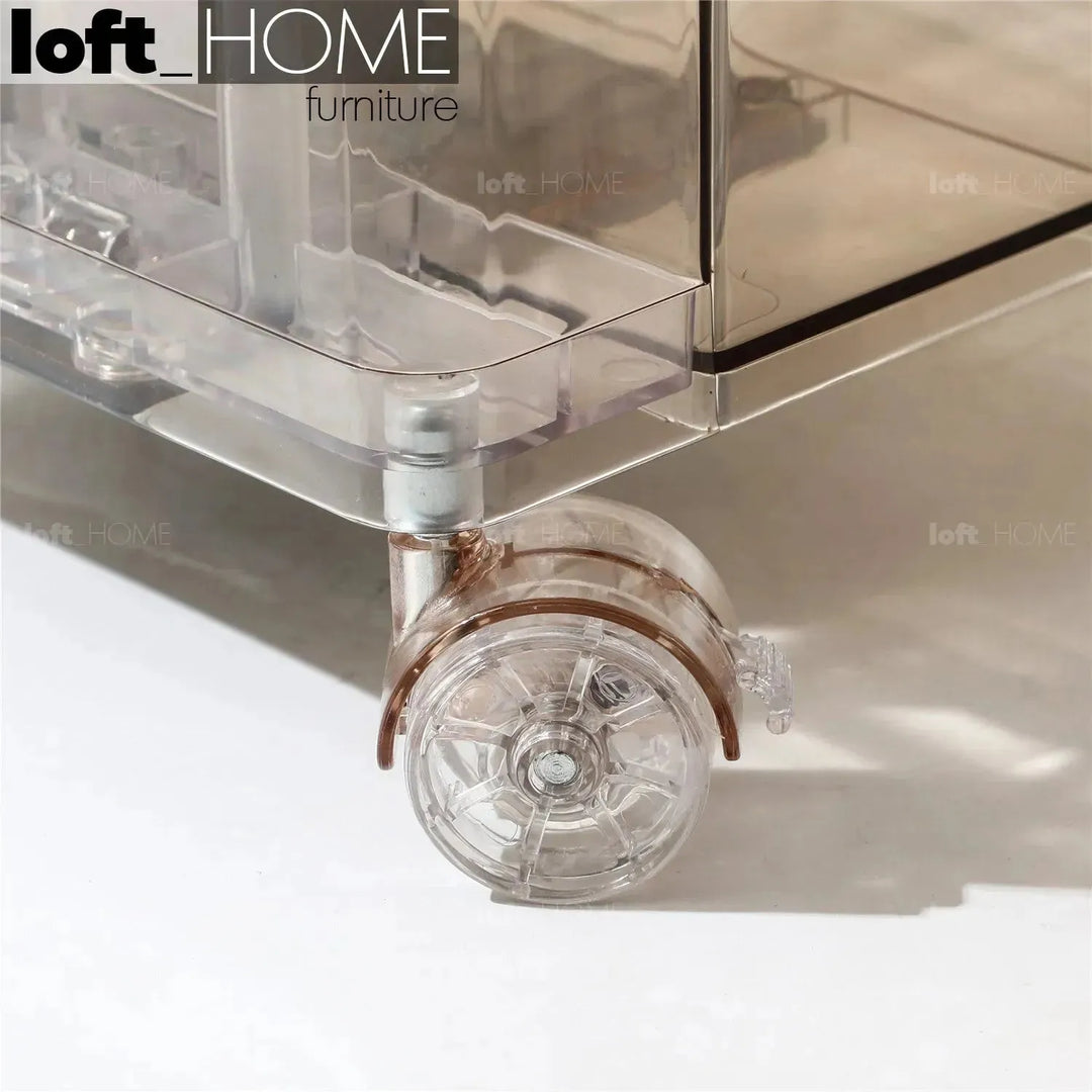 Contemporary plastic wheeled trolley side table rolly clear in real life style.