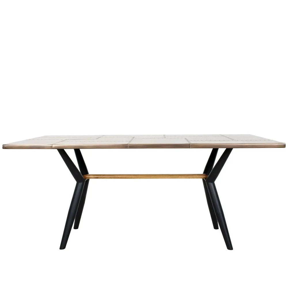 Industrial brass dining table lucien brass in white background.