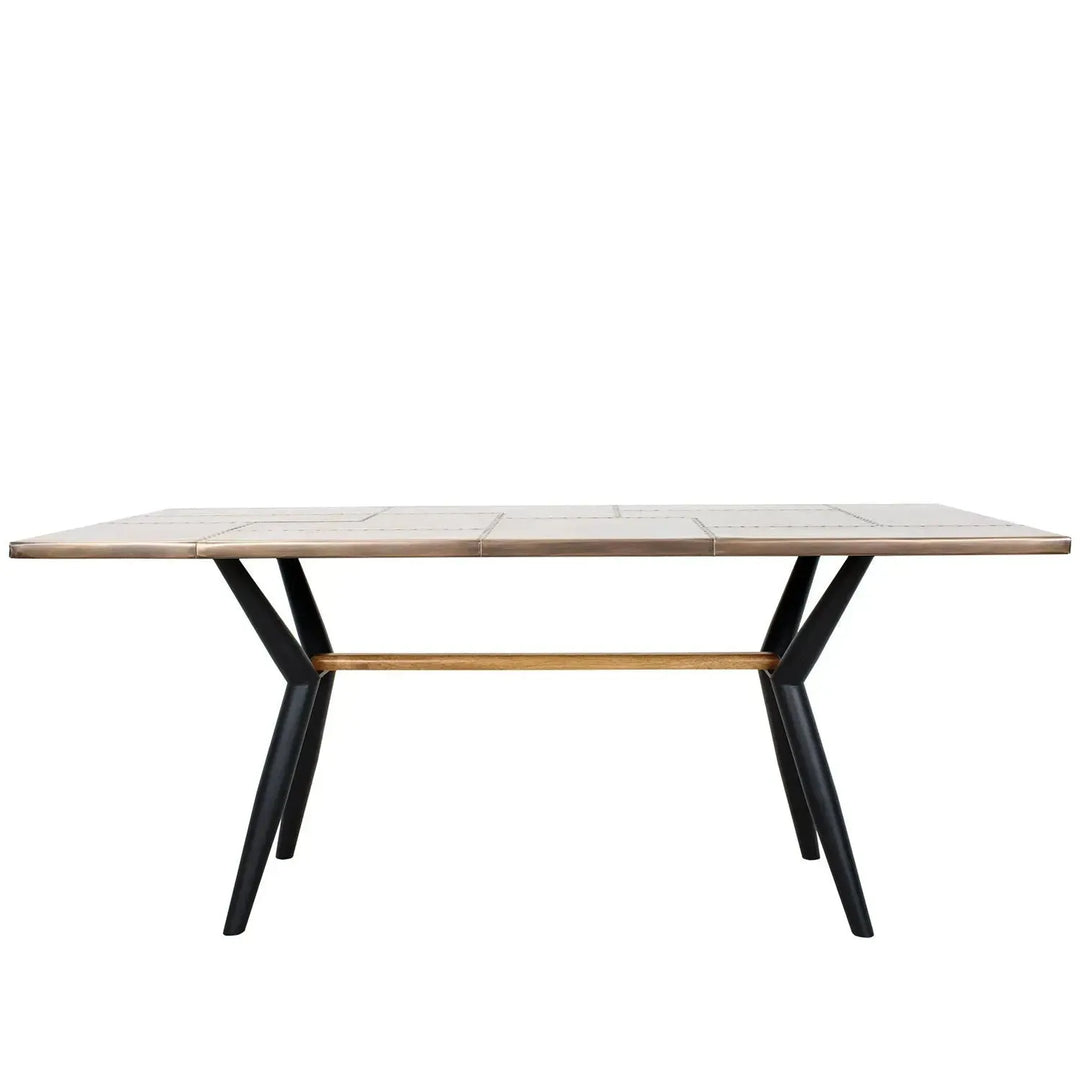 Industrial brass dining table lucien brass in white background.