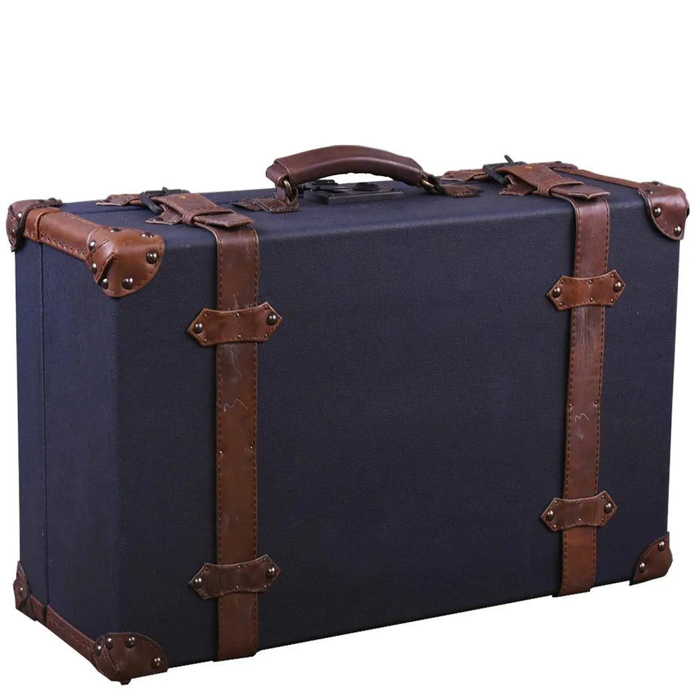 Vintage canvas and genuine leather side table suitcase trunk 1920s in white background.