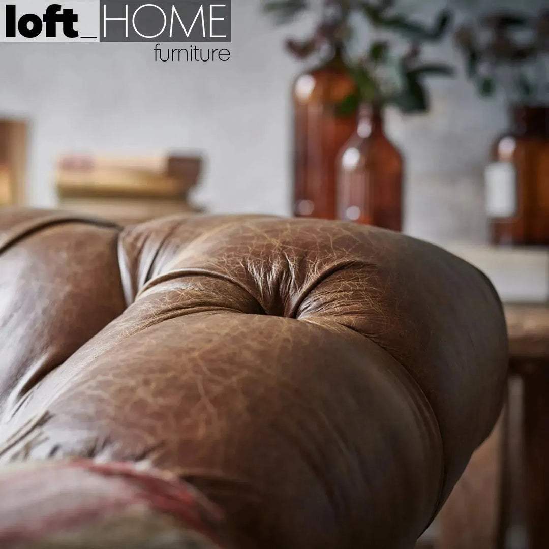 Vintage genuine leather 1 seater sofa chesterfield button in panoramic view.