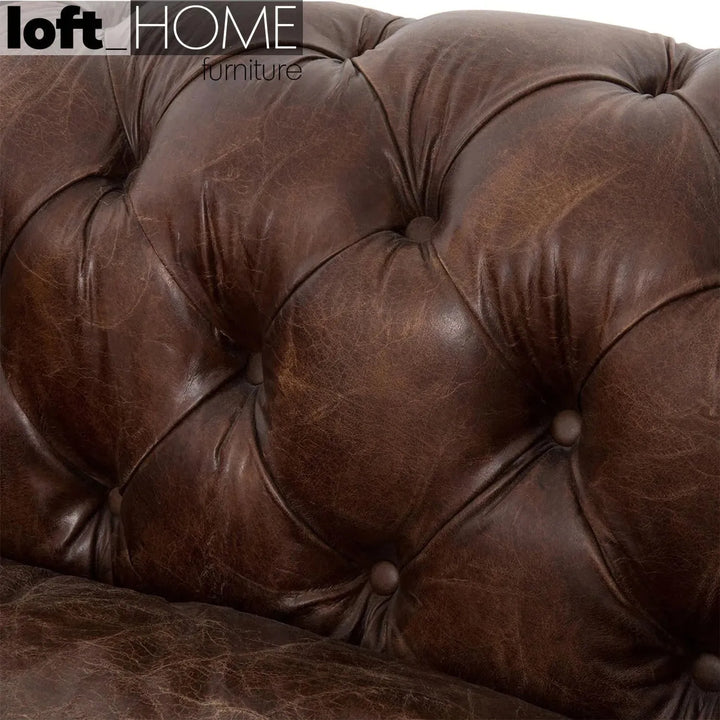 Vintage genuine leather 2 seater sofa chesterfield button with context.