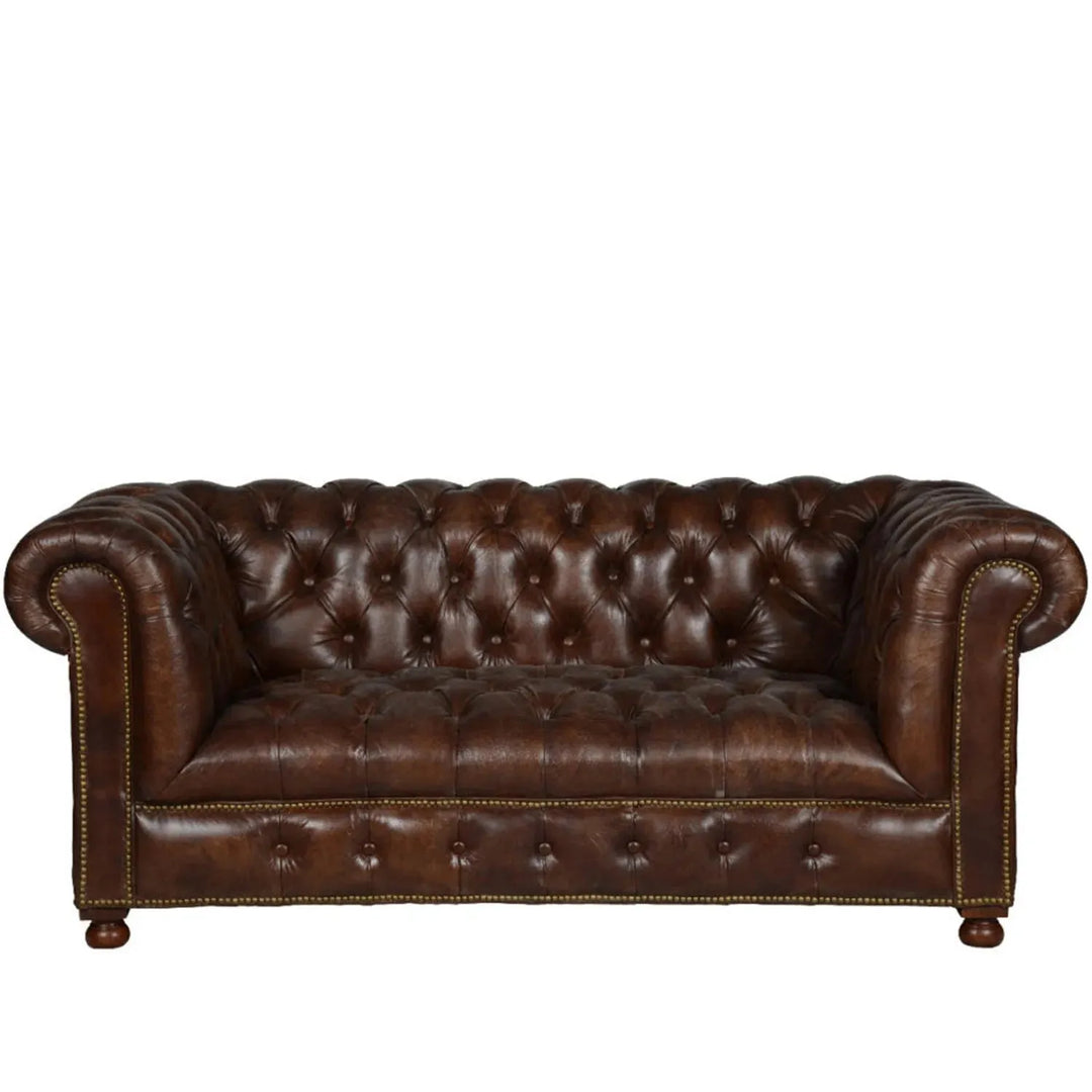Vintage genuine leather 2 seater sofa chesterfield button in white background.