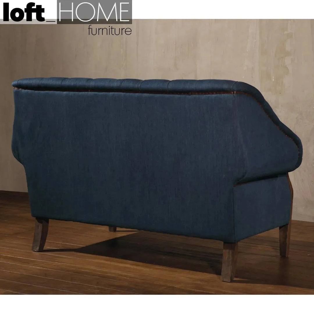 Vintage jeans fabric and genuine leather 2 seater sofa cowboy in close up details.