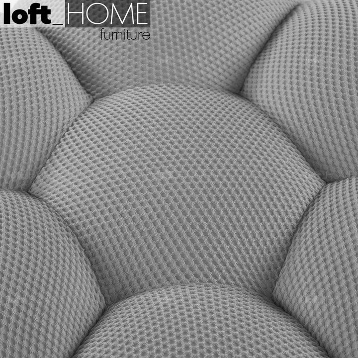 Contemporary fabric round ottoman bubble layered structure.