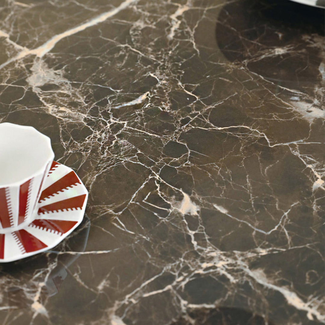 Dark ceramic surface with natural stone veining, highlighting refined texture and durability, adding a sleek accent to modern interiors.