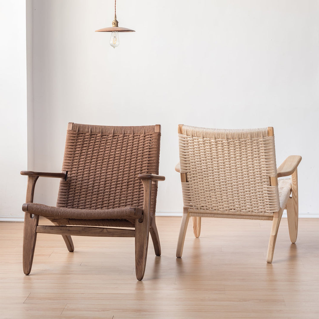 Pair of woven lounge chairs in natural wood frames, featuring light and dark finishes, perfect for minimalist and Scandinavian interiors.