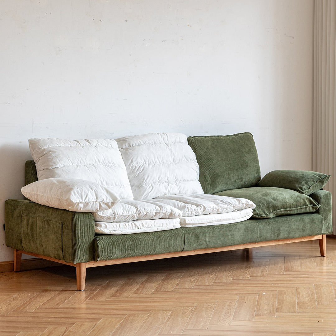 Premium green corduroy fabric 3-seater sofa with removable white cushion covers, styled for cozy modern living, enhancing Loft Home’s premium sofa collection.