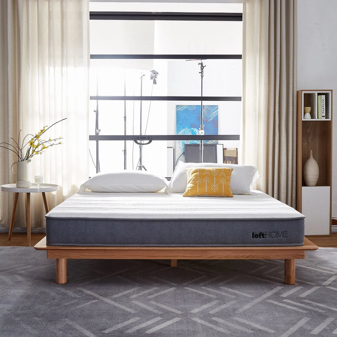 Bright bedroom with an Asia queen-size mattress on a wooden bed frame. Explore the Asia queen-size mattress collection at Loft Home Furniture.