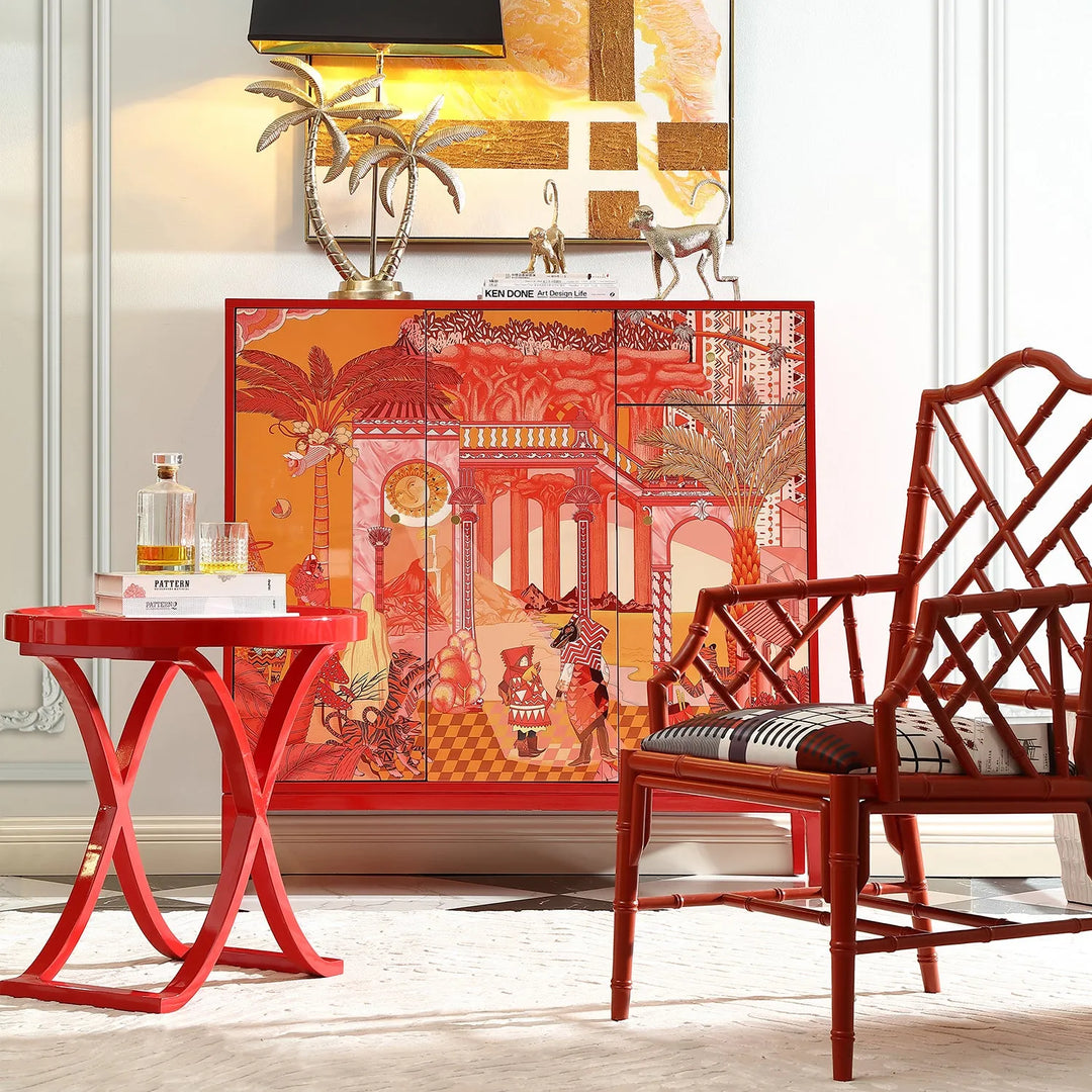 Eclectic home decor featuring a vibrant red table, an intricate red cabinet with tropical and architectural designs, and a stylish chair with geometric patterns - ideal for bold and artistic interiors.