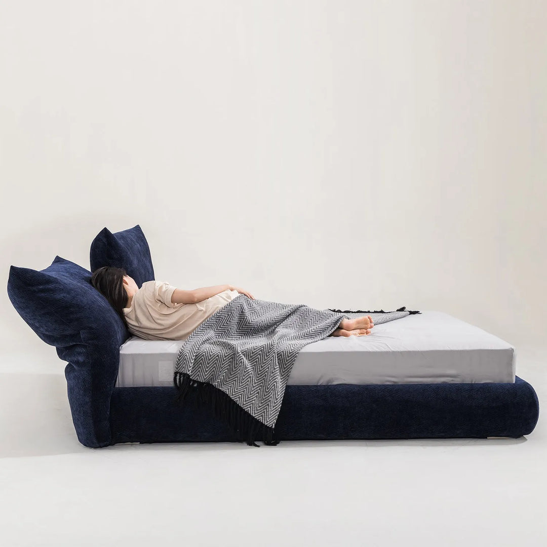 Comfortable fabric bed frame with a navy blue upholstered headboard and cozy bedding, perfect for modern bedroom interiors, linking to Loft Home's fabric bed frame collection.