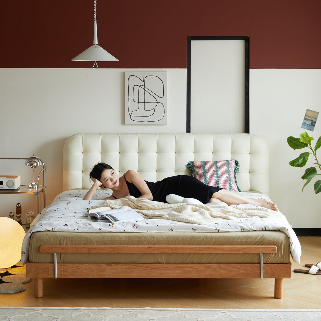 Modern bedroom featuring a microfiber leather bed frame, cozy bedding, minimalist decor, and a relaxing ambiance with soft lighting and greenery.