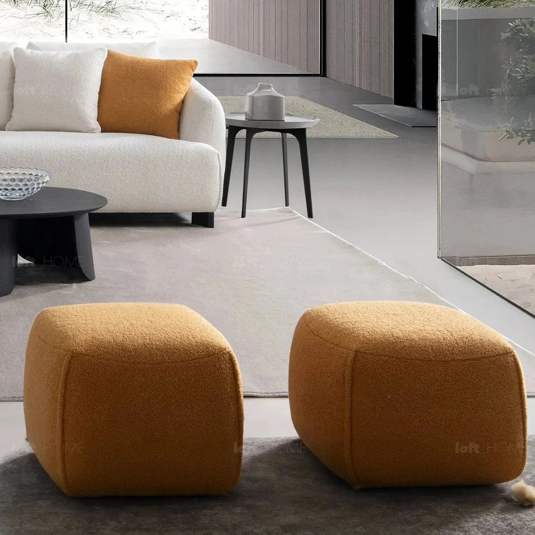 Cream sherpa fabric ottoman saffron in close up details.