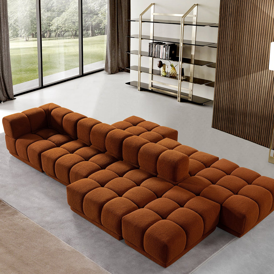 Modern living room with a bold modular sofa in warm brown tones, offering customizable seating and a luxurious, minimalist design.