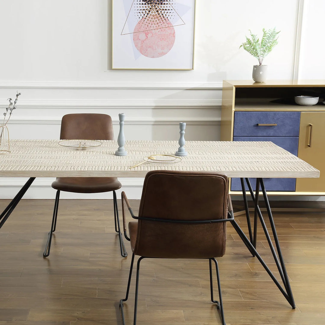 Scandinavian dining room setup featuring a light wood table with sleek metal legs, brown leather chairs, and minimalist decor elements, perfect for a modern and clean home interior.