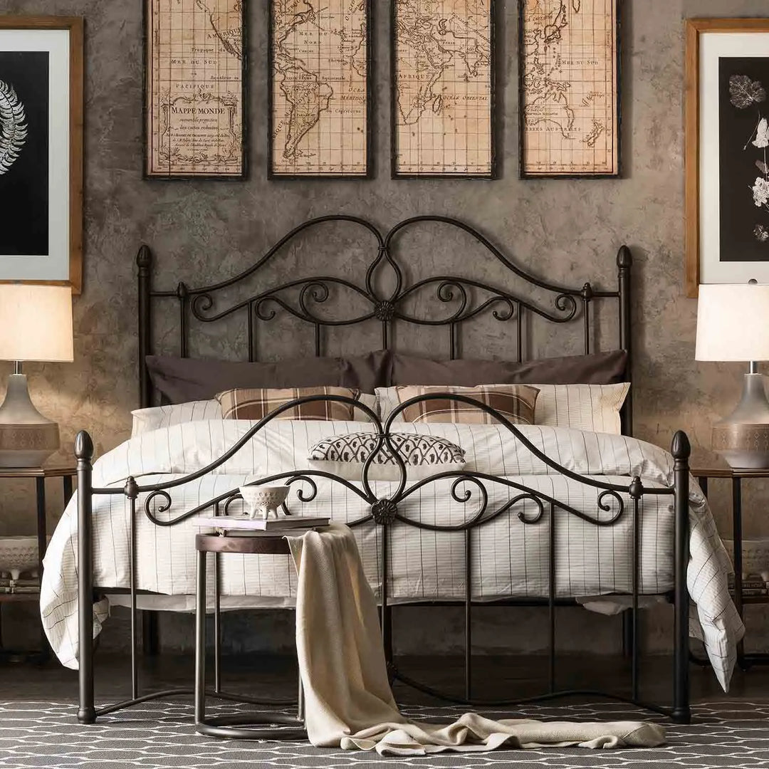 Featured in Loft Home's beds collection: Elegant bedroom with an ornate iron bed frame, cozy bedding, vintage world map wall art, and warm ambient lighting.