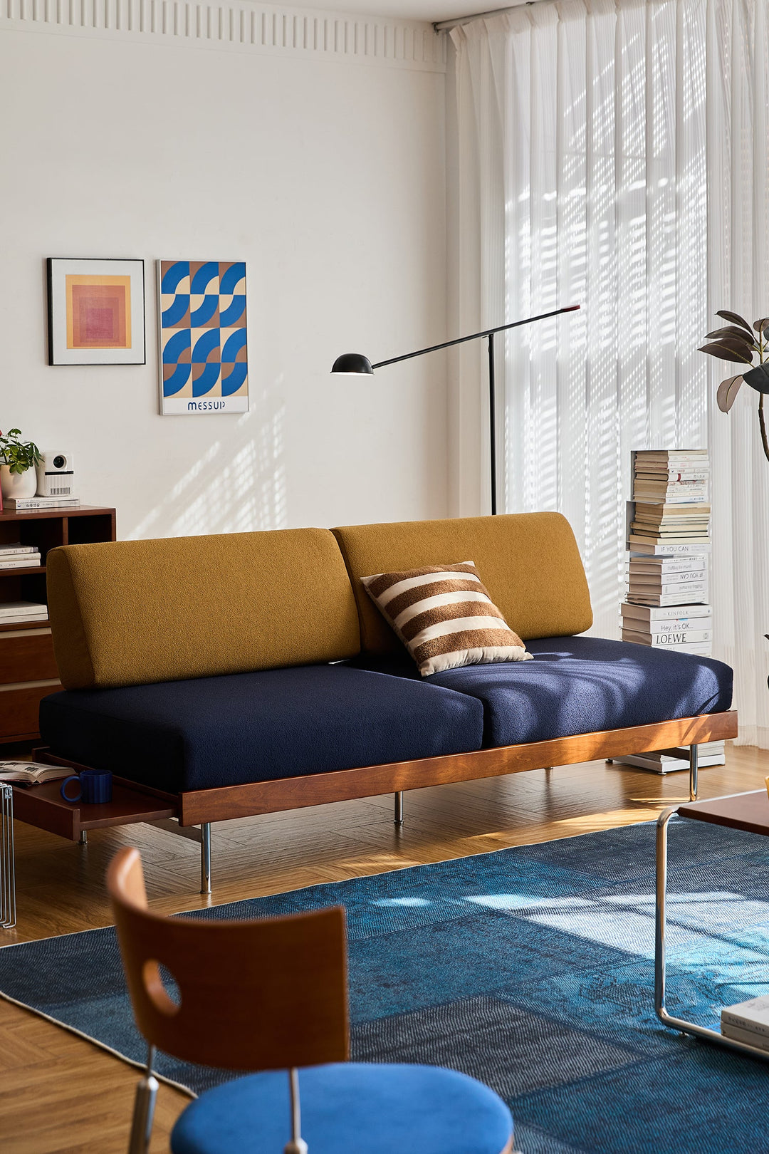 Bauhaus-inspired sofa with bold blue and mustard cushions, styled for modern Singapore apartments and designer living rooms.
