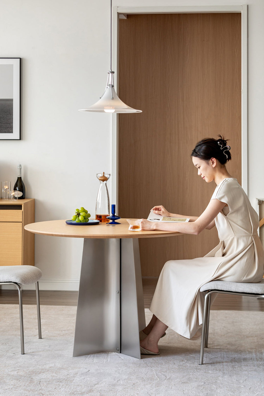 Bauhaus-inspired round dining table with wood top and metal base, styled for Singapore condos, HDB dining areas, and modern apartments.