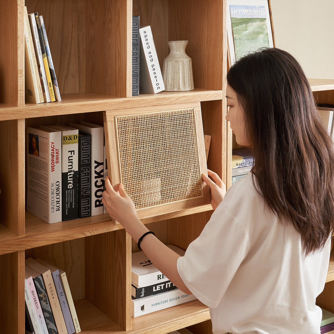 Modern wooden bookshelf with rattan doors, combining open and concealed storage options, ideal for keeping books and decor organized while adding a stylish touch to any room.