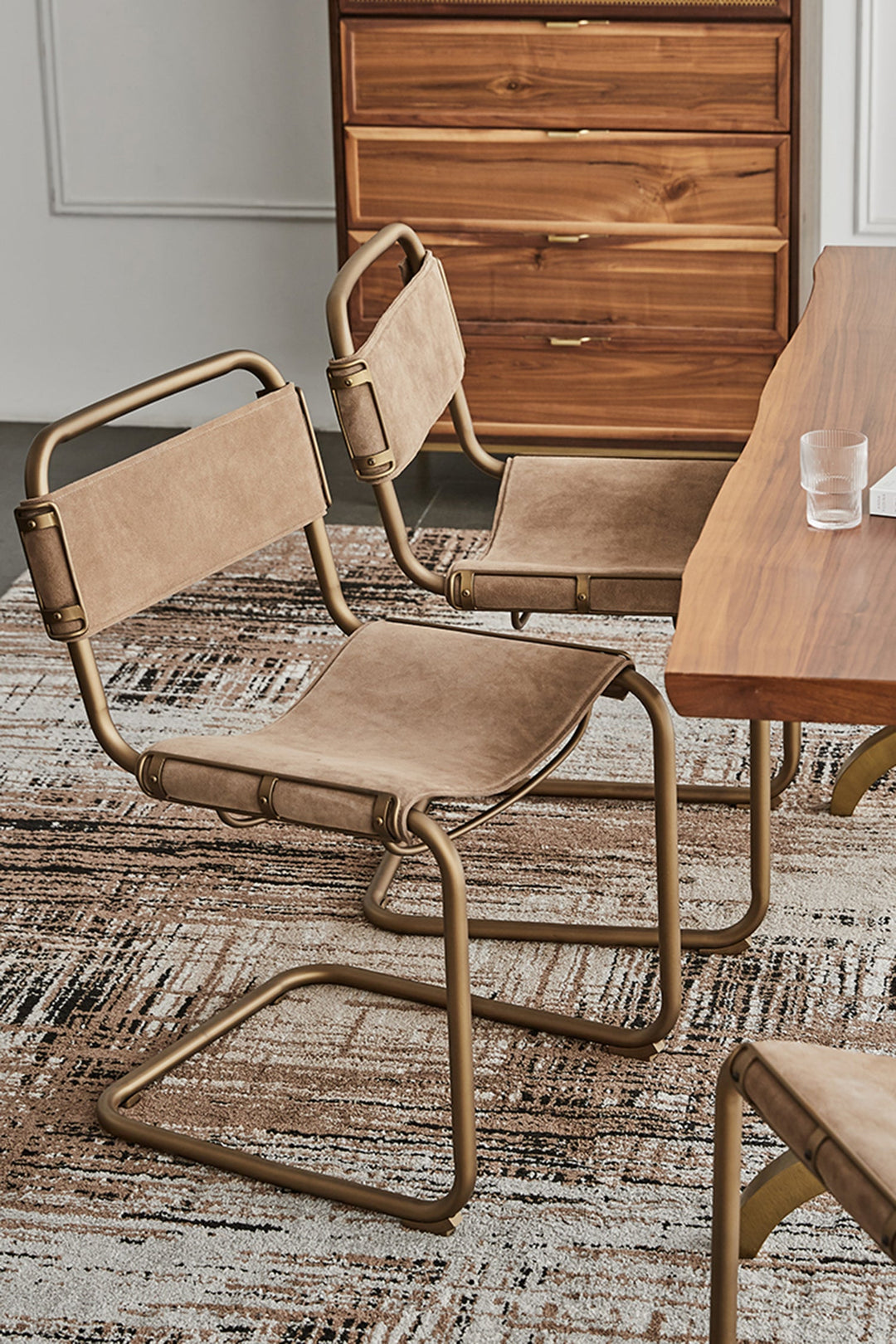 Brass dining chairs with vintage leather seats, styled for Singapore dining rooms, condos, HDB flats, and industrial-inspired interiors.