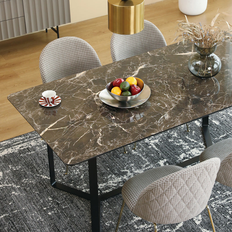 Loft Home ceramic dining table collection featuring a polished brown marble-effect ceramic tabletop with sturdy black metal legs, paired with quilted chairs for a sophisticated dining experience.