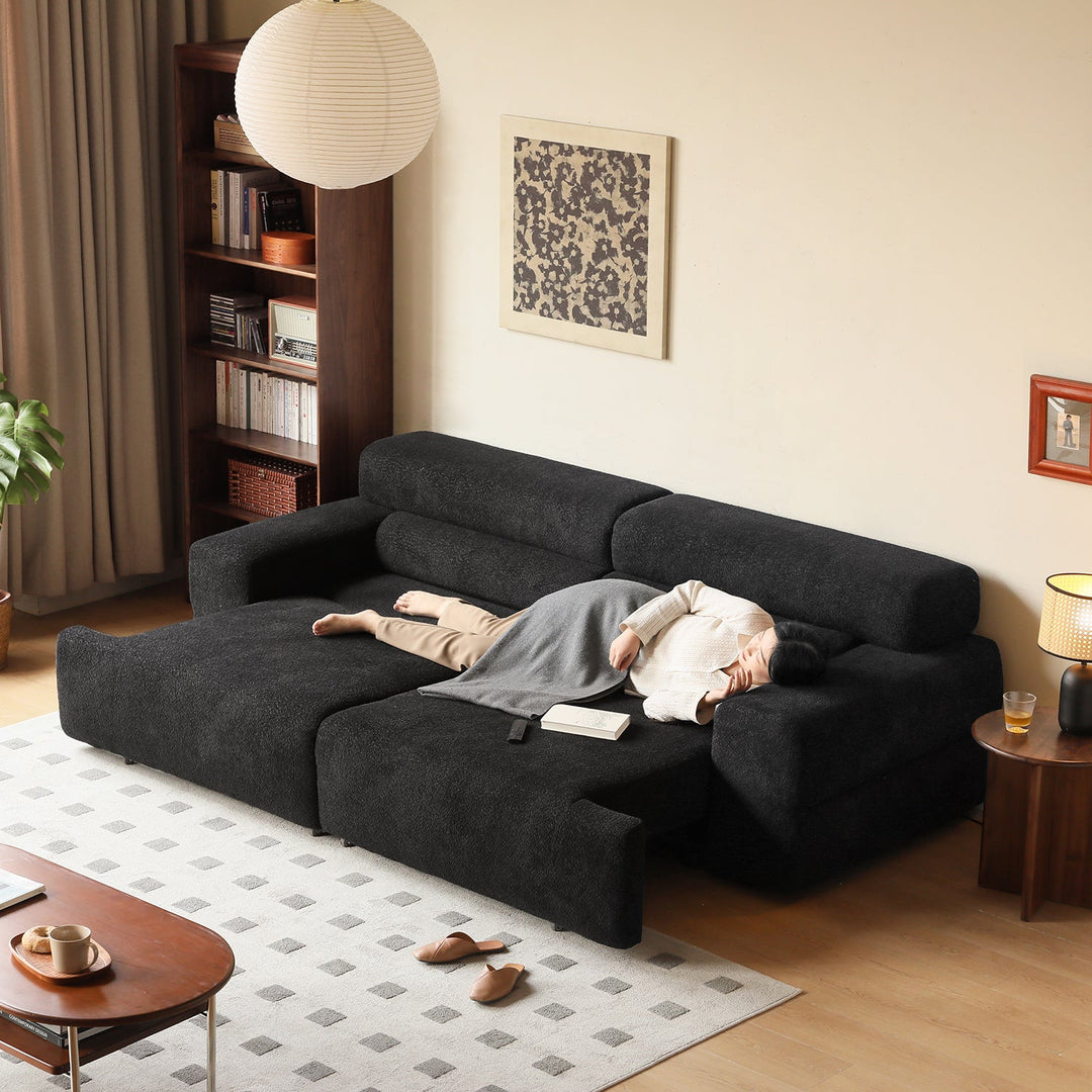 Loft Home cream sofa bed collection, featuring a black fabric sofa bed with adjustable backrest and spacious seating, designed for modern living spaces and multifunctional relaxation.