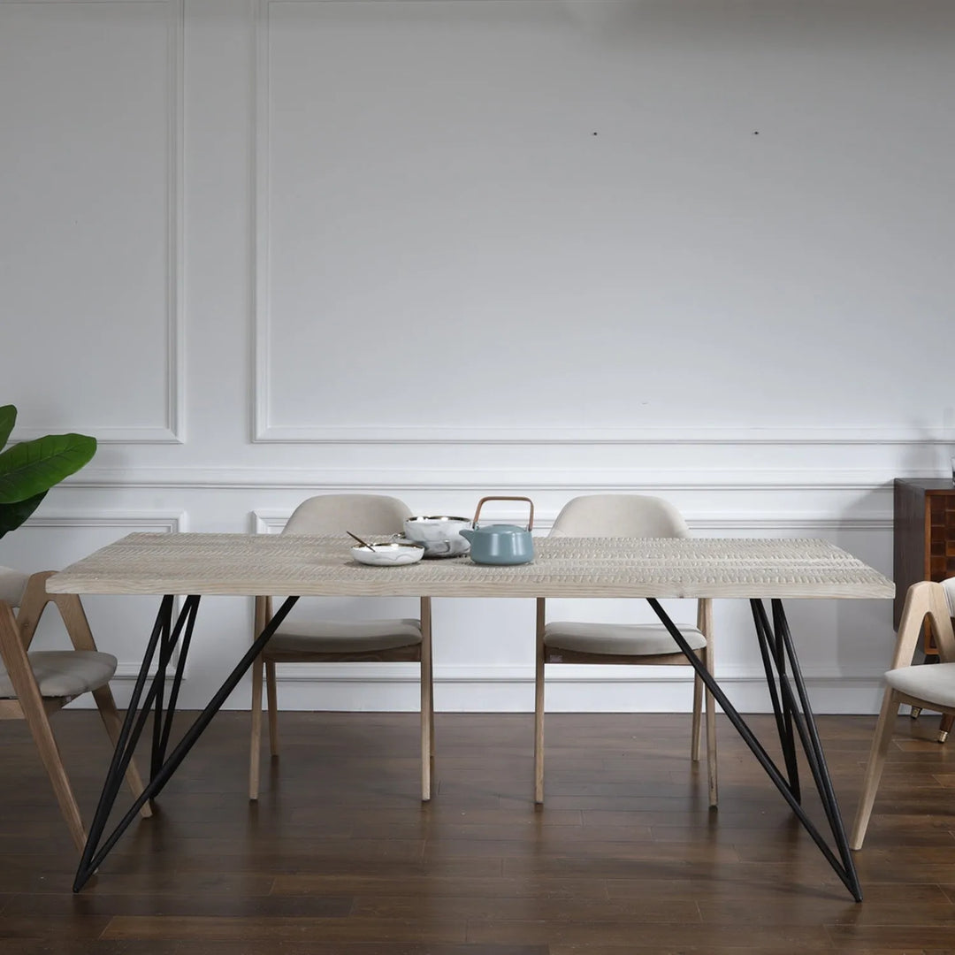 Elegant wooden dining table set with matching chairs and bench, creating a warm and inviting space for meals and relaxation.