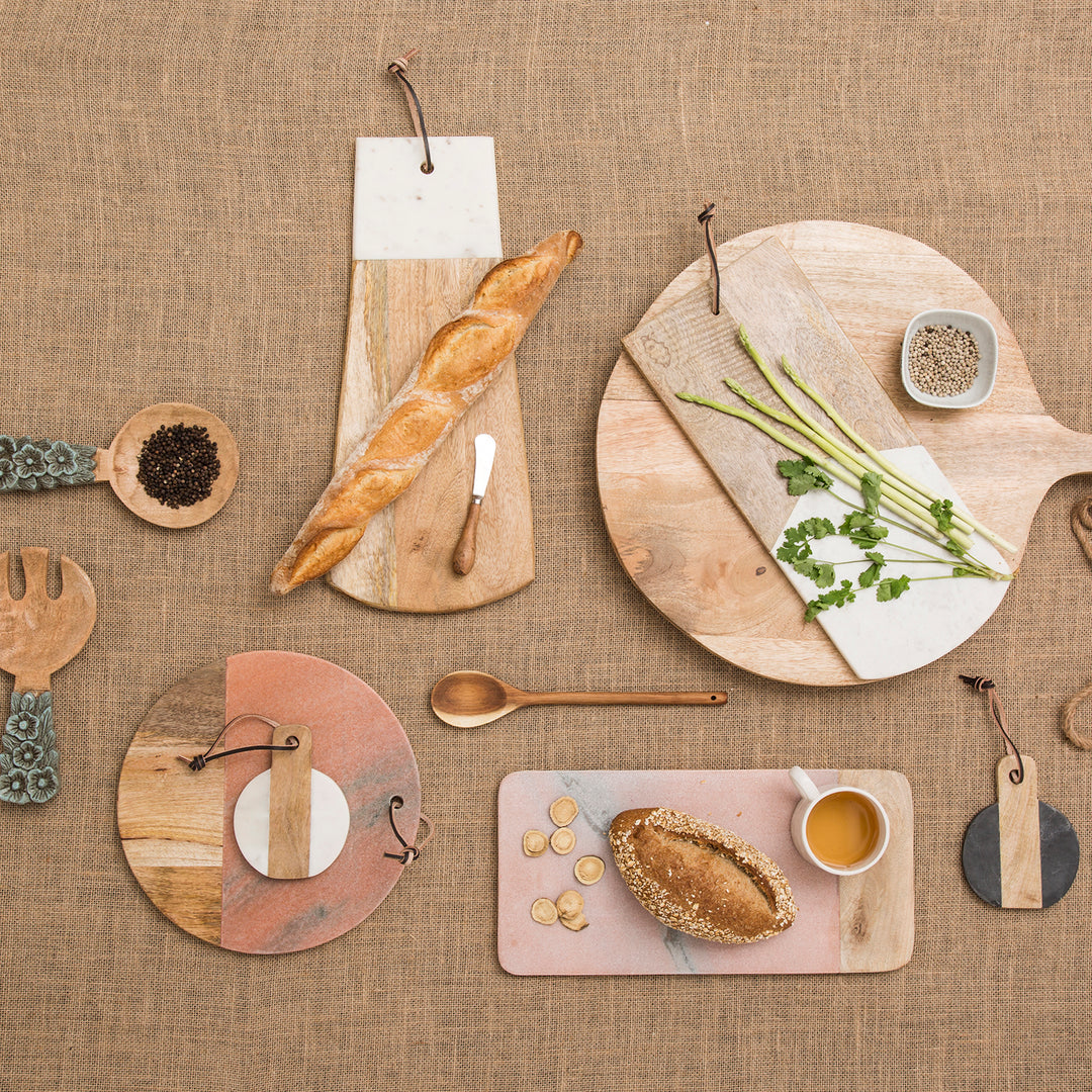 Loft Home rustic kitchen setup featuring wooden cutting boards, fresh bread, vegetables, and natural elements for a cozy and stylish dining experience.