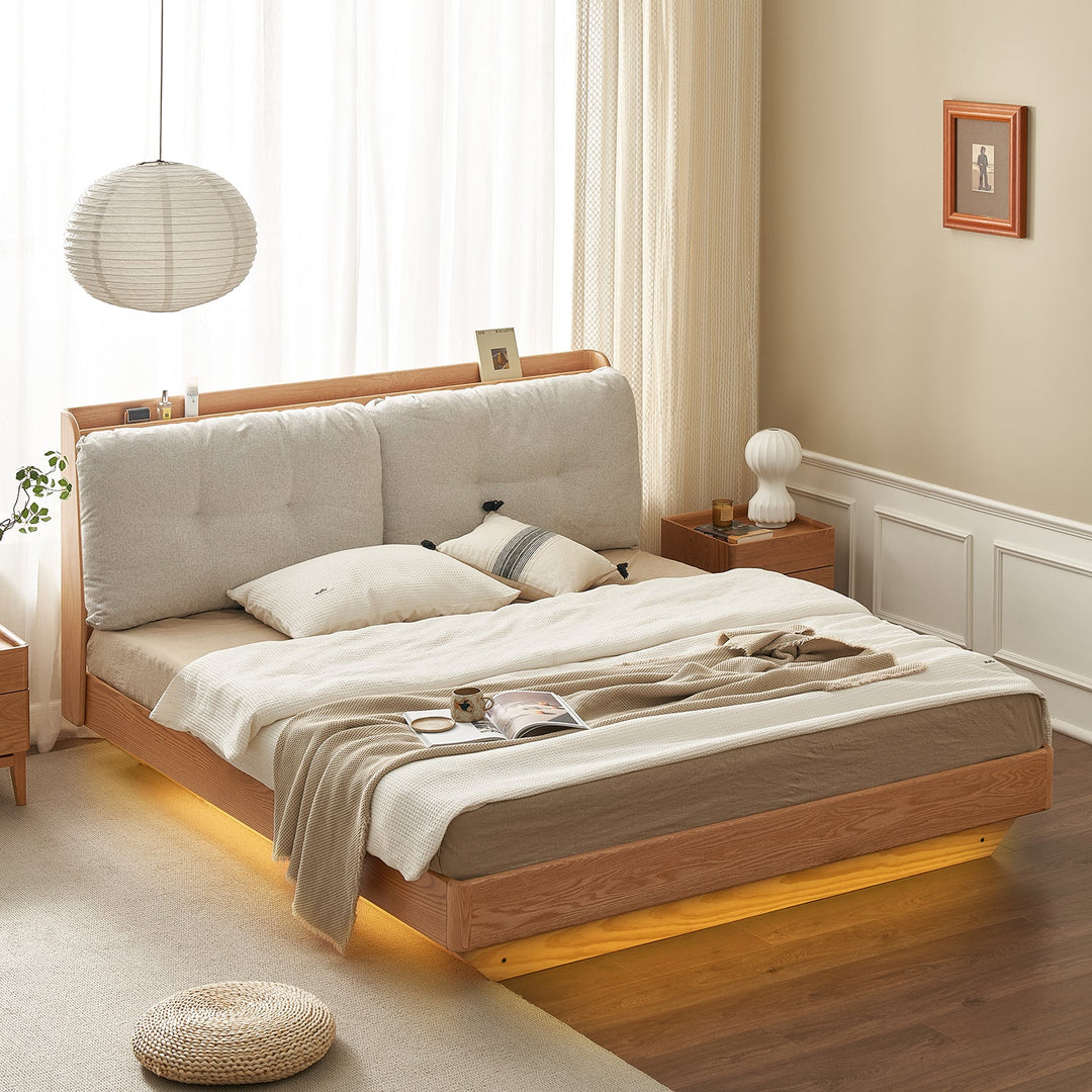 Divan bed frame with an upholstered headboard, warm underbed lighting, and a natural wooden finish, creating a cozy and elegant bedroom centerpiece.