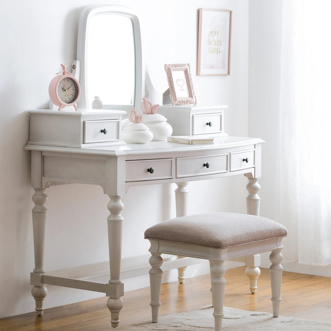 Wooden dressing table with built-in storage, styled with accessories and decor, perfect for organizing personal items in a cozy bedroom setting.