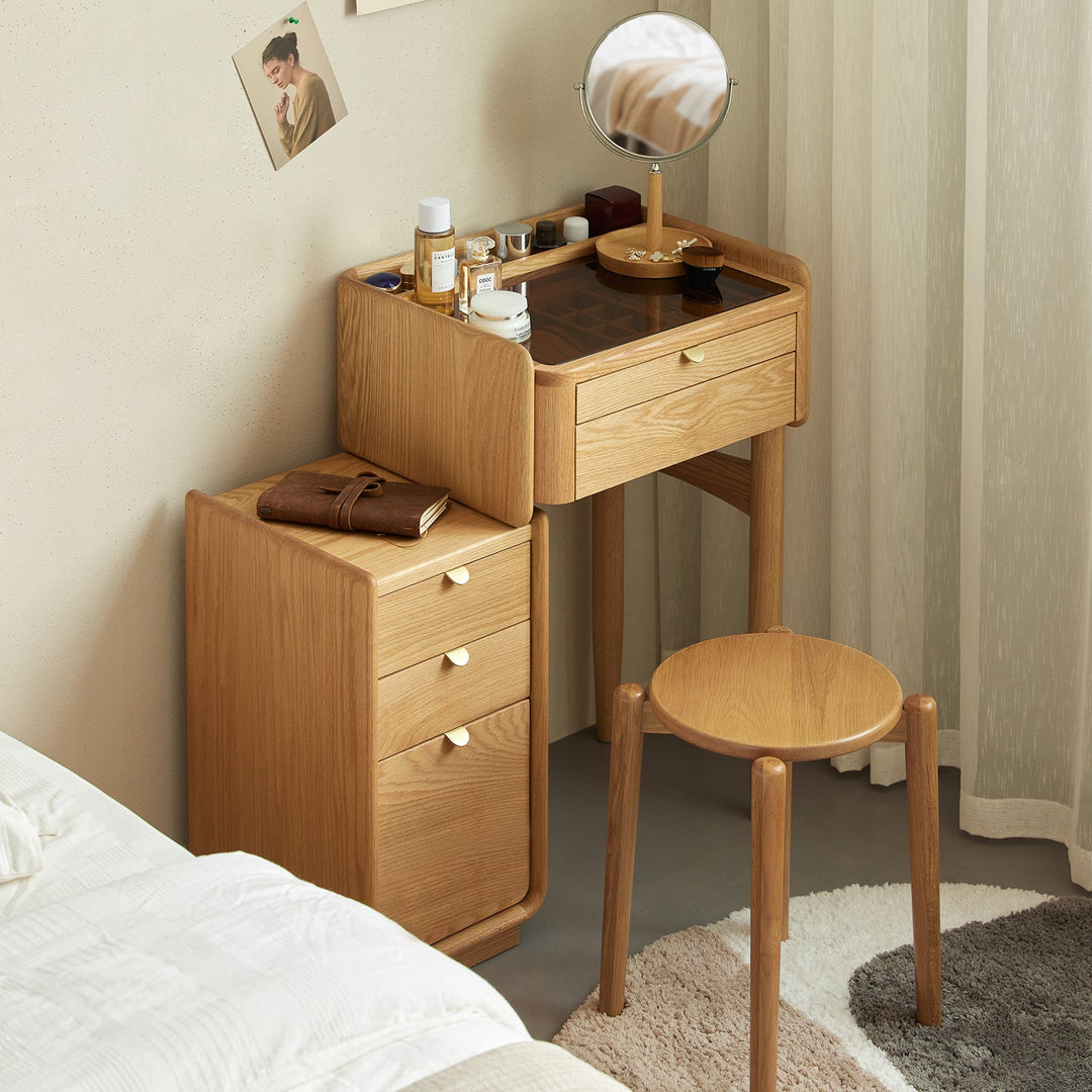 Compact wooden dressing table with integrated storage drawers and a stool, designed for efficient organization and a cozy bedroom setup.