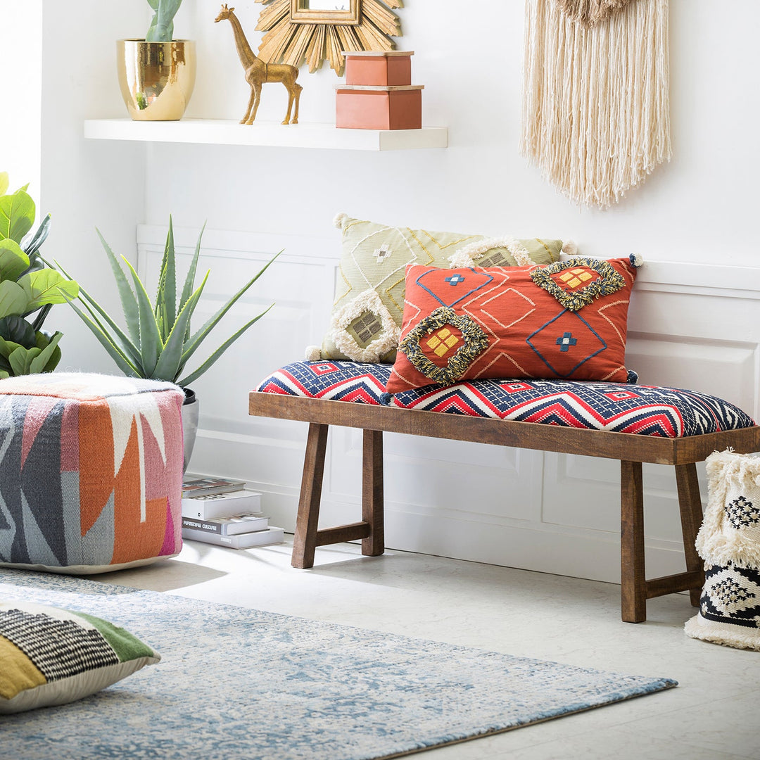 Loft Home entryway bench with vibrant patterned cushions, styled with colorful decor and greenery, creating a lively and welcoming space.