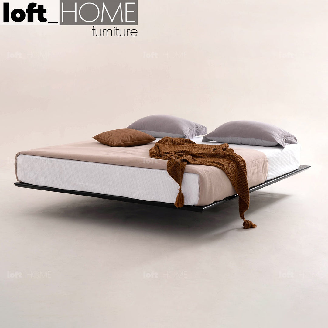 Modern folding bed with neutral bedding, soft pillows, and a cozy brown throw, offering a sleek and space-saving solution for any bedroom.