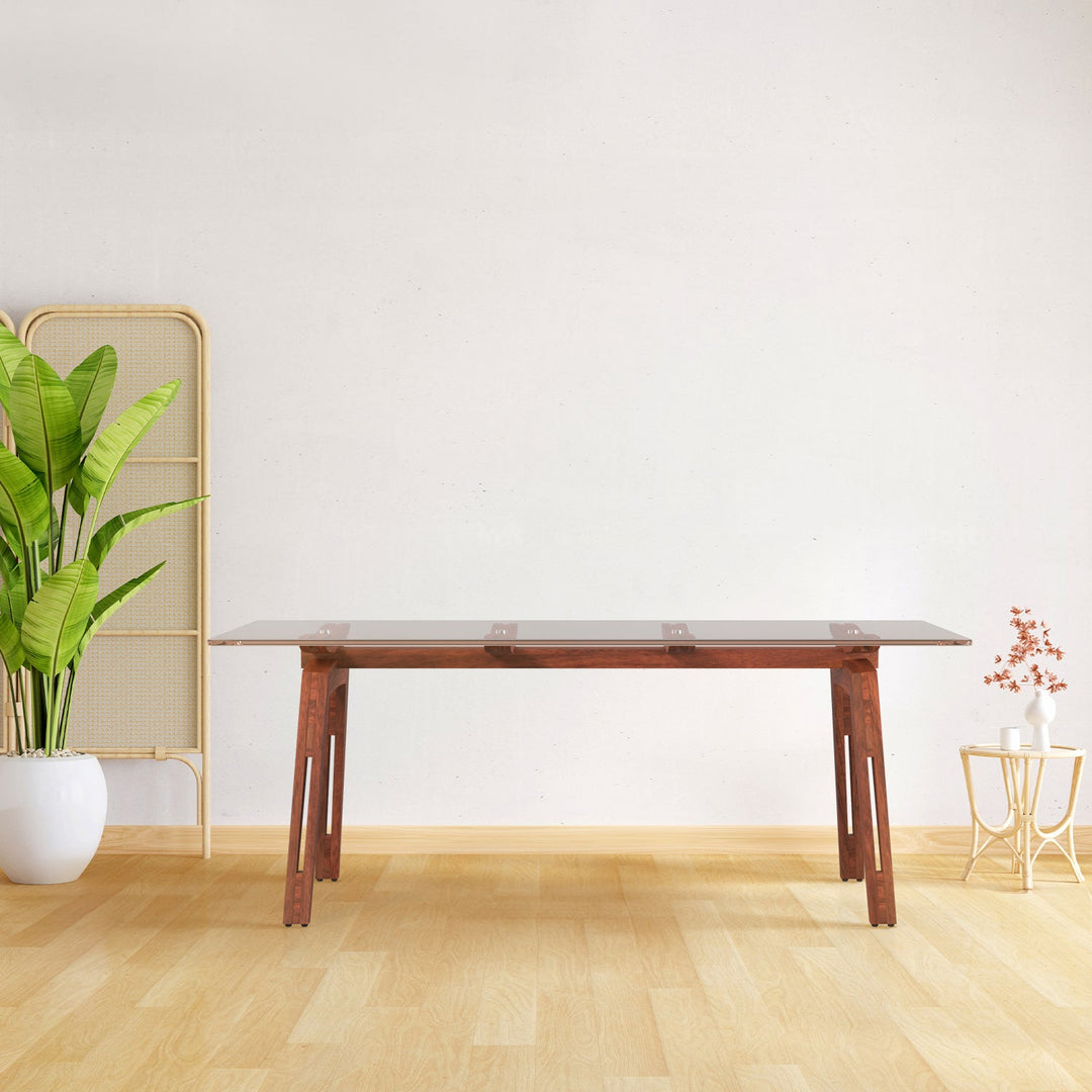 Loft Home glass dining table collection, featuring a sleek tempered glass tabletop with walnut wood legs, styled in a minimalist dining space with natural greenery, offering a modern and elegant dining solution.