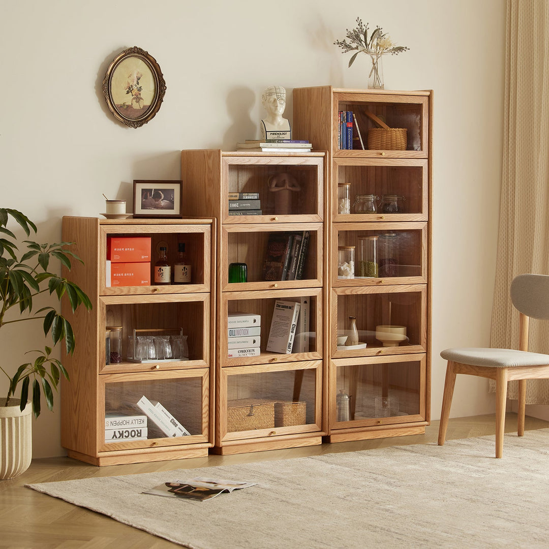 Oak glass-front storage cabinets, stackable and versatile, ideal for showcasing books and decor, adding elegance to modern interiors.