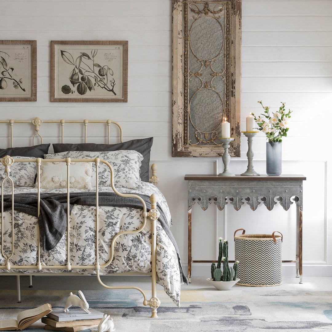 Japandi-style bedroom with an elegant metal bed frame, floral bedding, rustic decor, and soft neutral tones, blending minimalism with cozy charm.