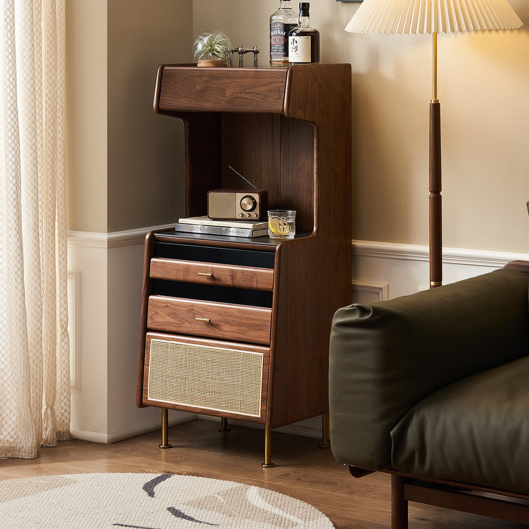 Walnut-finish Japandi-style storage cabinet with woven rattan accents, styled with a retro radio and modern lamp, perfect for minimalist living spaces.