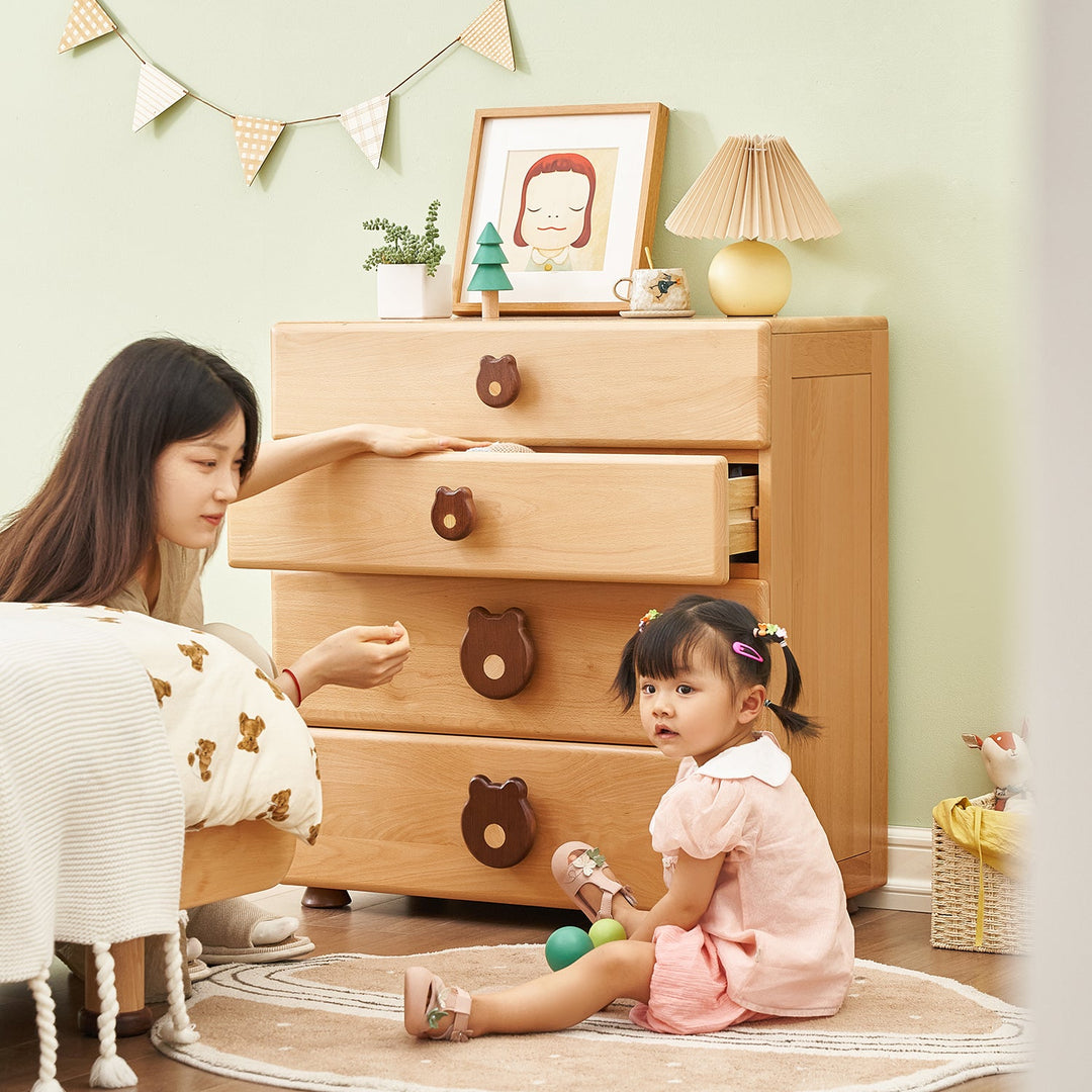 Kids' wooden chest of drawers with adorable bear-shaped handles, offering playful and functional storage, perfect for organizing toys and clothes in children's bedrooms.