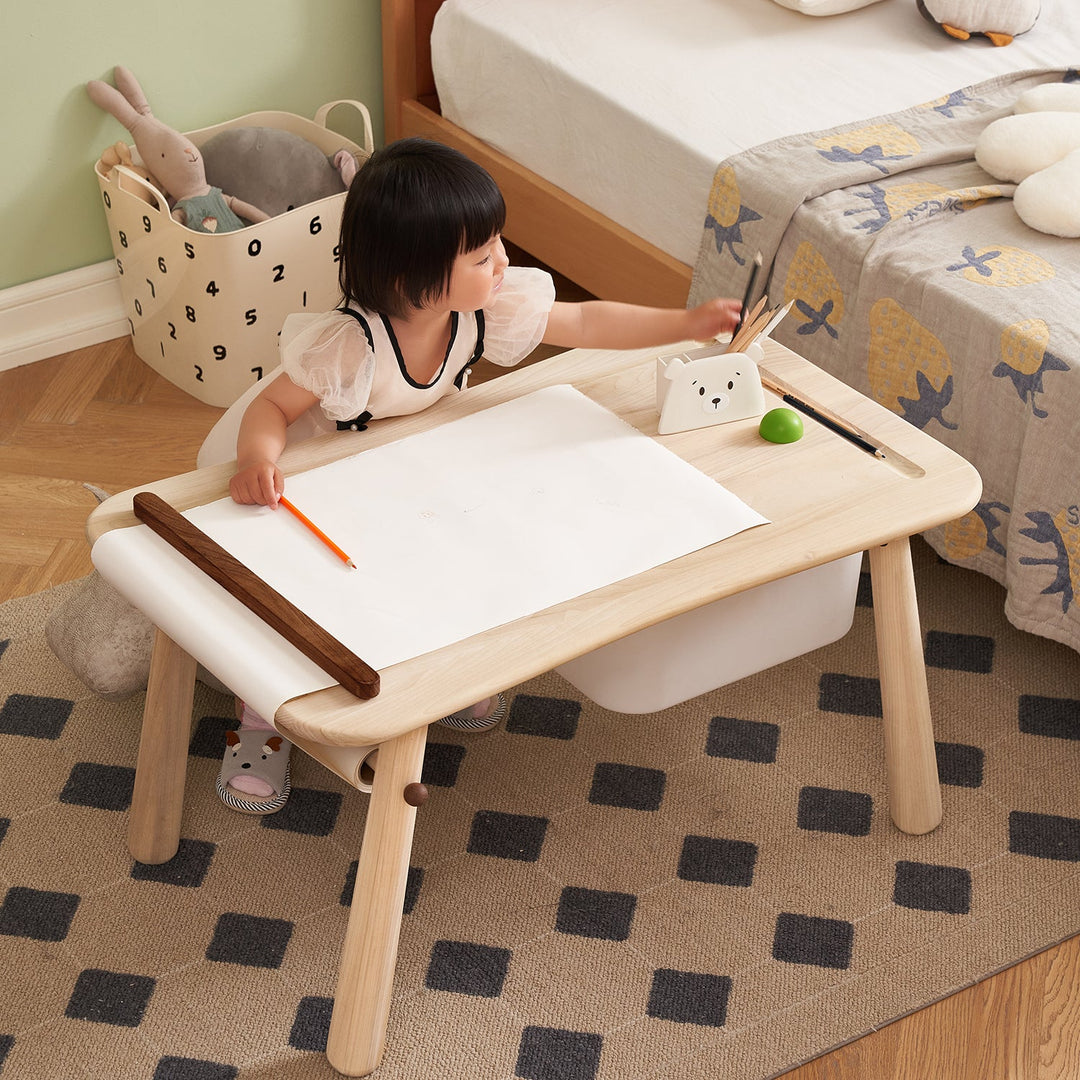 Children's study table with a smooth wooden surface, built-in paper roll, and storage, fostering creativity and organization in kids' rooms.