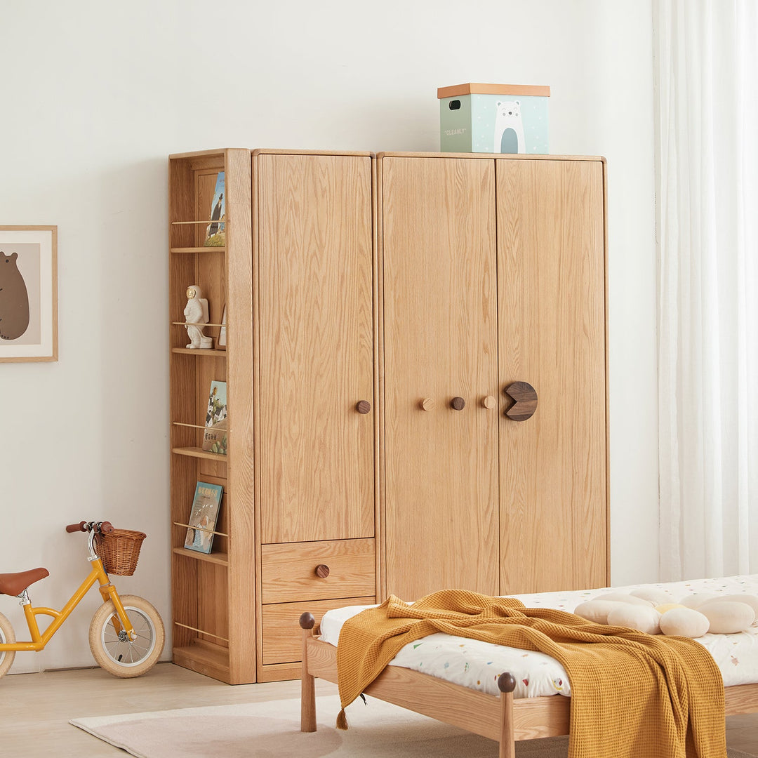 Kids' wooden wardrobe with playful knob handles and built-in shelving, offering organized storage and charming design for children's rooms.