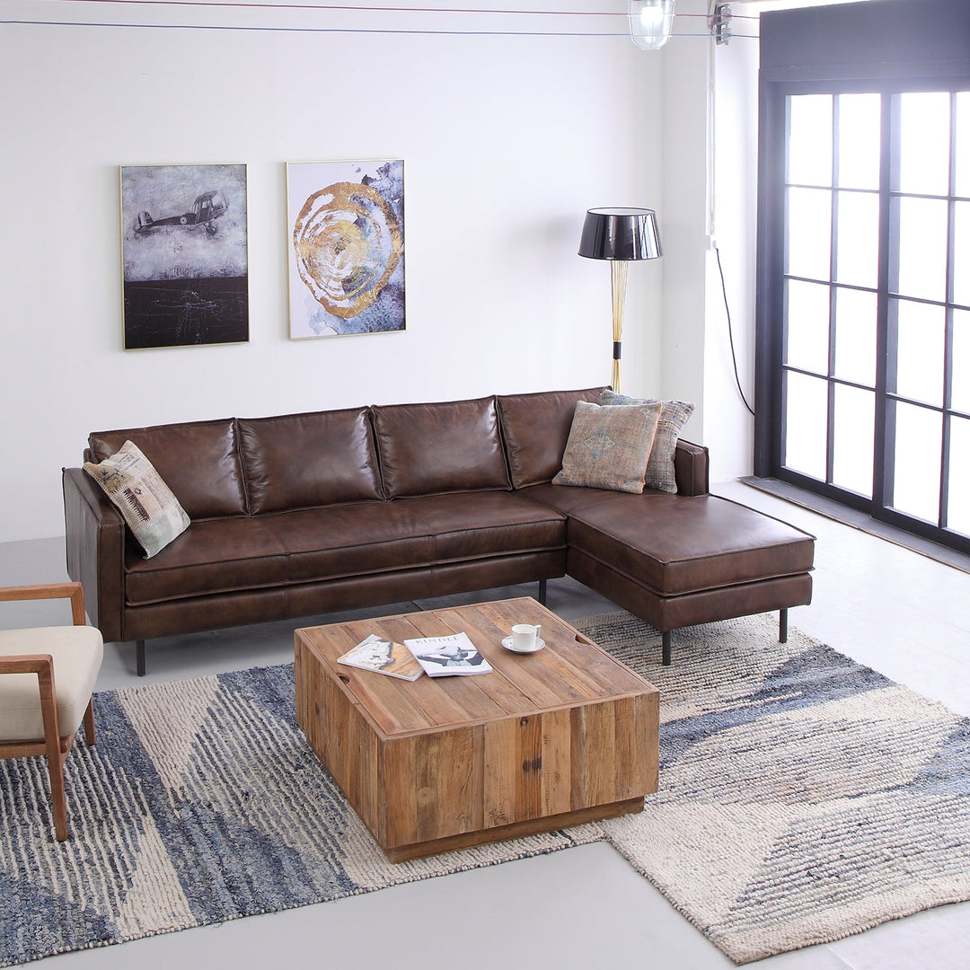 Loft Home L-shaped leather sofa in rich brown, featuring a sleek chaise lounge, paired with rustic accents for a modern-industrial living room vibe.