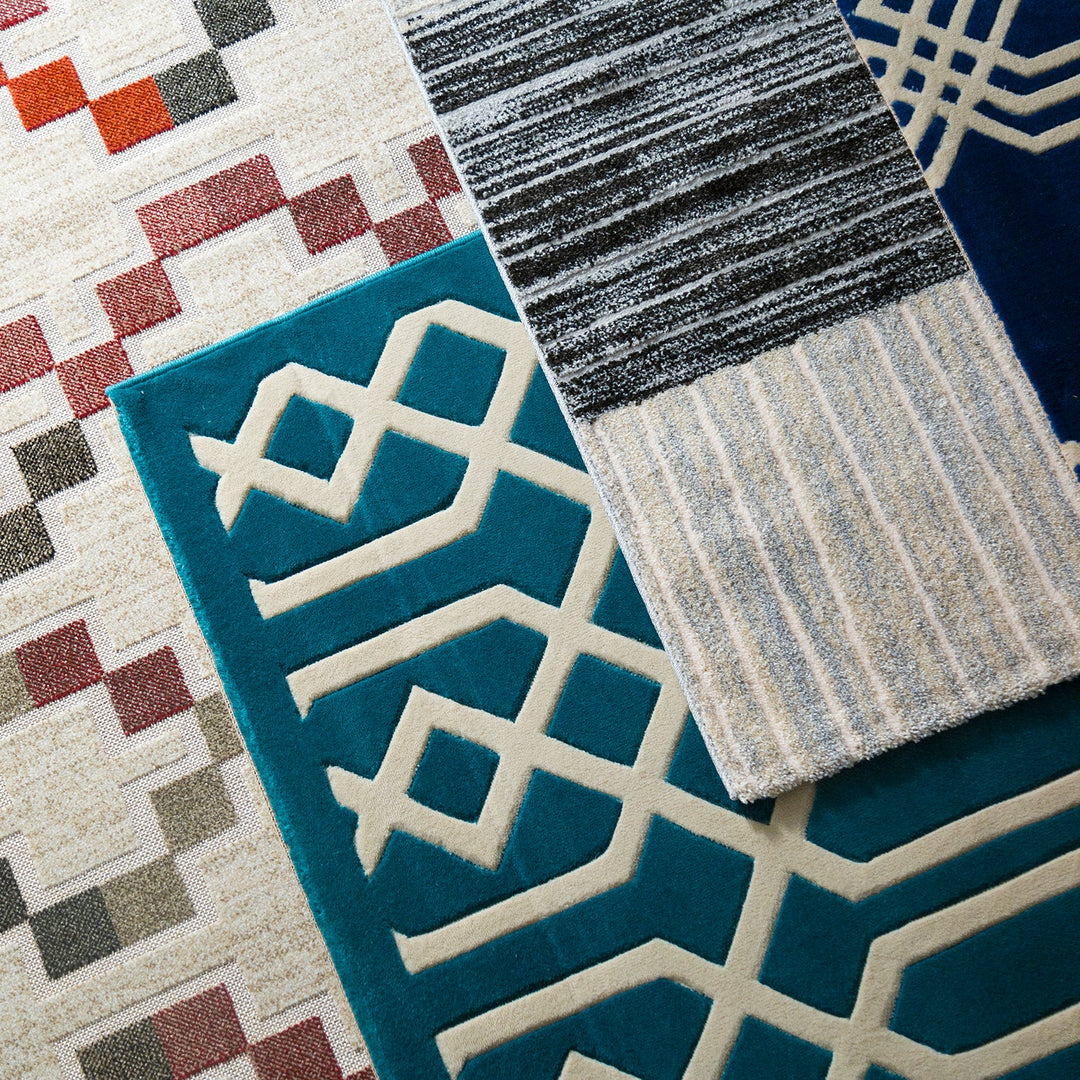 Selection of modern rugs featuring geometric, striped, and textured patterns in vibrant and neutral tones, ideal for adding style to any space.