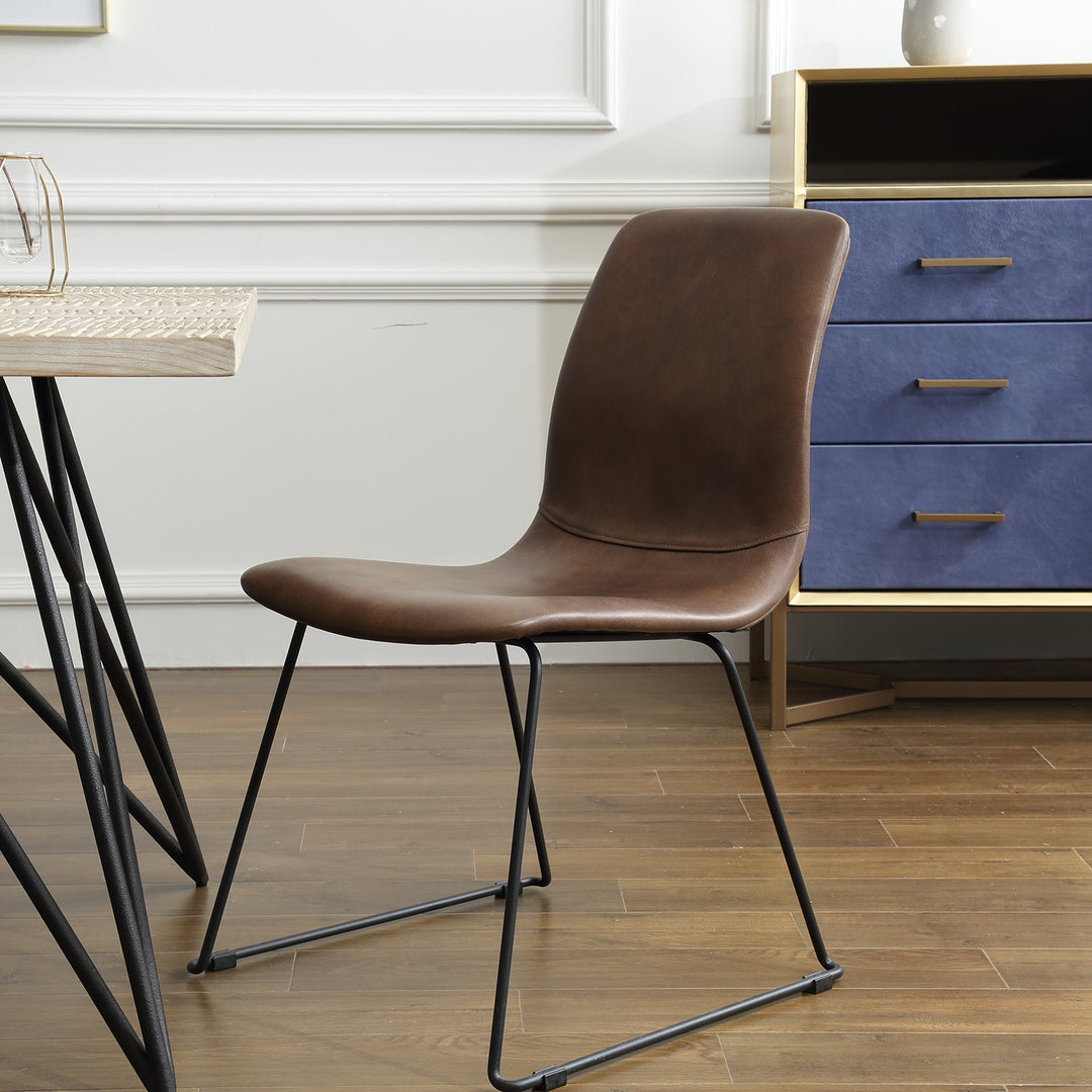 Modern brown leather dining chair with sleek black metal legs, perfect for contemporary dining rooms or office spaces.